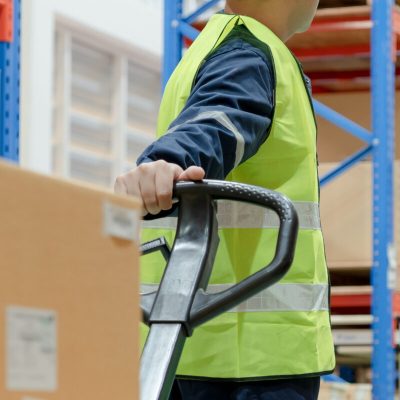 vecteezy_warehouse-worker-pull-pallet-truck-after-inspects-goods-in_18973528